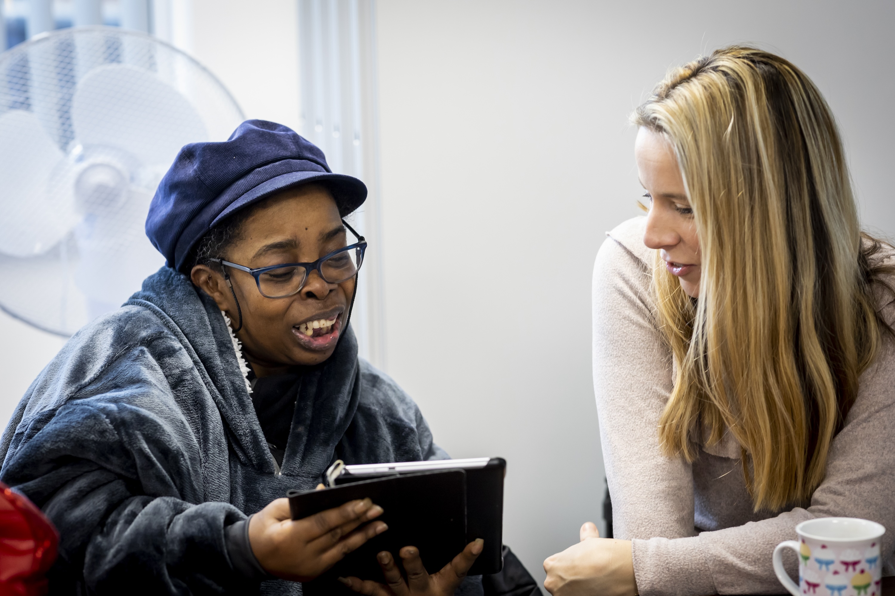 2 people using a tablet