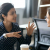 two women at computers talking